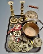 A tray containing antique and later brass ware including a pair of 19th century candlesticks,