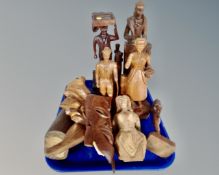 A tray containing seven assorted carved wooden figures together with two wall masks.