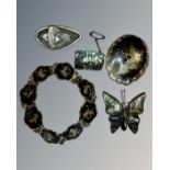 A collection of silver, niello and mother of pearl jewellery.