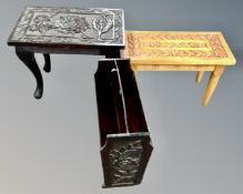 Two carved occasional tables together with a carved magazine rack.