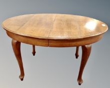 A Scandinavian oval oak dining table (length 138cm)