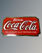 A modern 'Drink Coca-Cola Delicious and Refreshing' enamelled advertising sign.