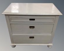 An antique pine three drawer chest on bun feet (width 79cm,