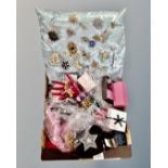 A box containing a collection of ornate brooches mounted on a cushion, costume jewellery,