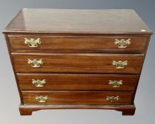 A 19th century four drawer chest with brass drop handles.