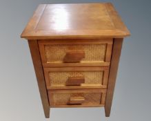A contemporary stained pine three drawer bedside chest (width 45cm)