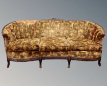 An early 20th century continental carved beech framed settee upholstered in a multicoloured fabric.