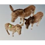 Three graduated Beswick figures of donkeys.