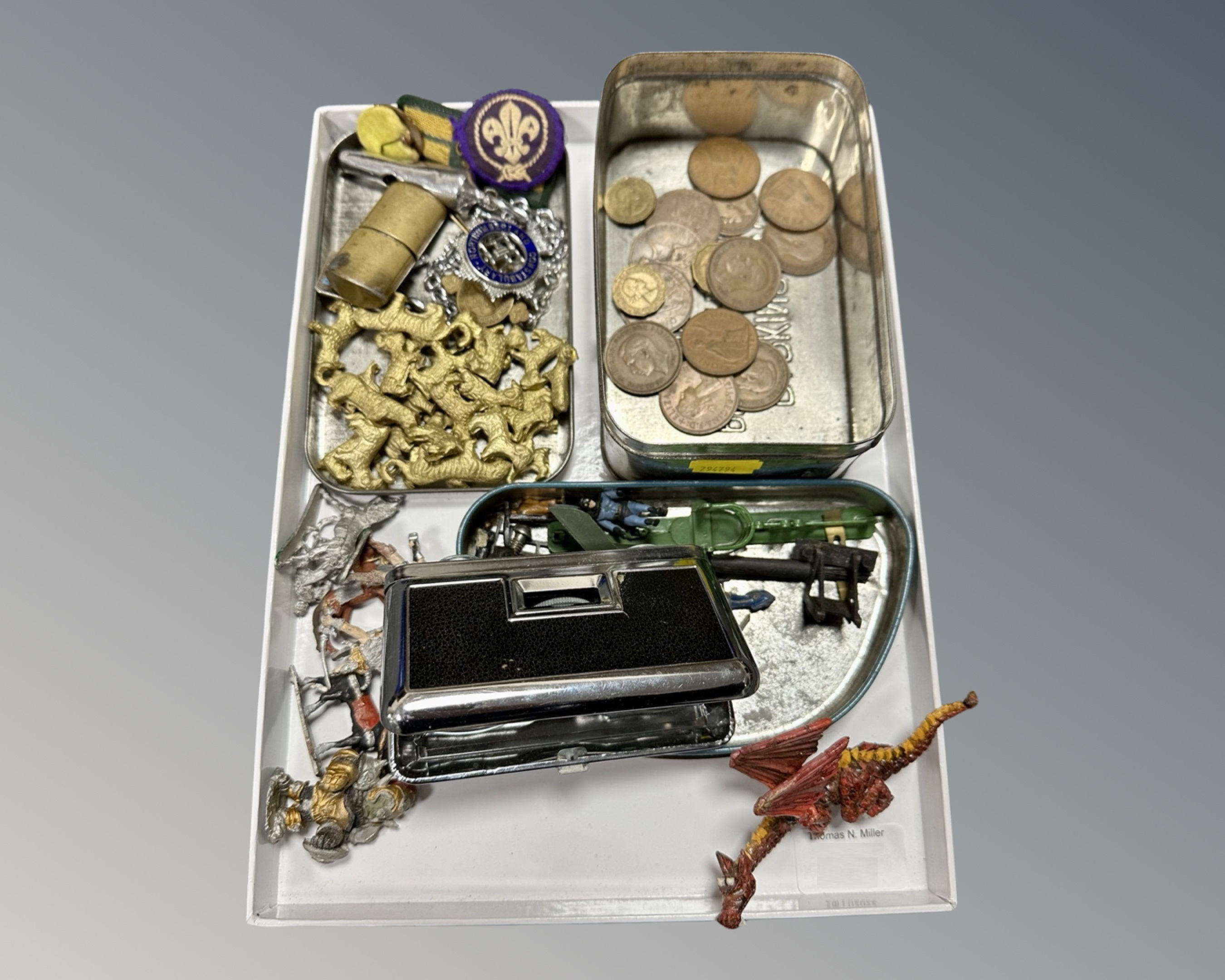 A tray containing miniature painted lead figures, a trench art lighter, whistle, scouting badges,