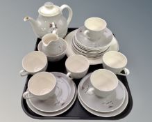 A tray containing a 24 piece Royal Doulton Forest Pine china tea service.