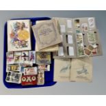 A tray containing a collection of cigarette card albums and loose cigarette cards by Wills and John