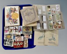 A tray containing a collection of cigarette card albums and loose cigarette cards by Wills and John