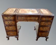 A mahogany and walnut nine drawer writing desk with brass drop handles (width 116cm) (AF)