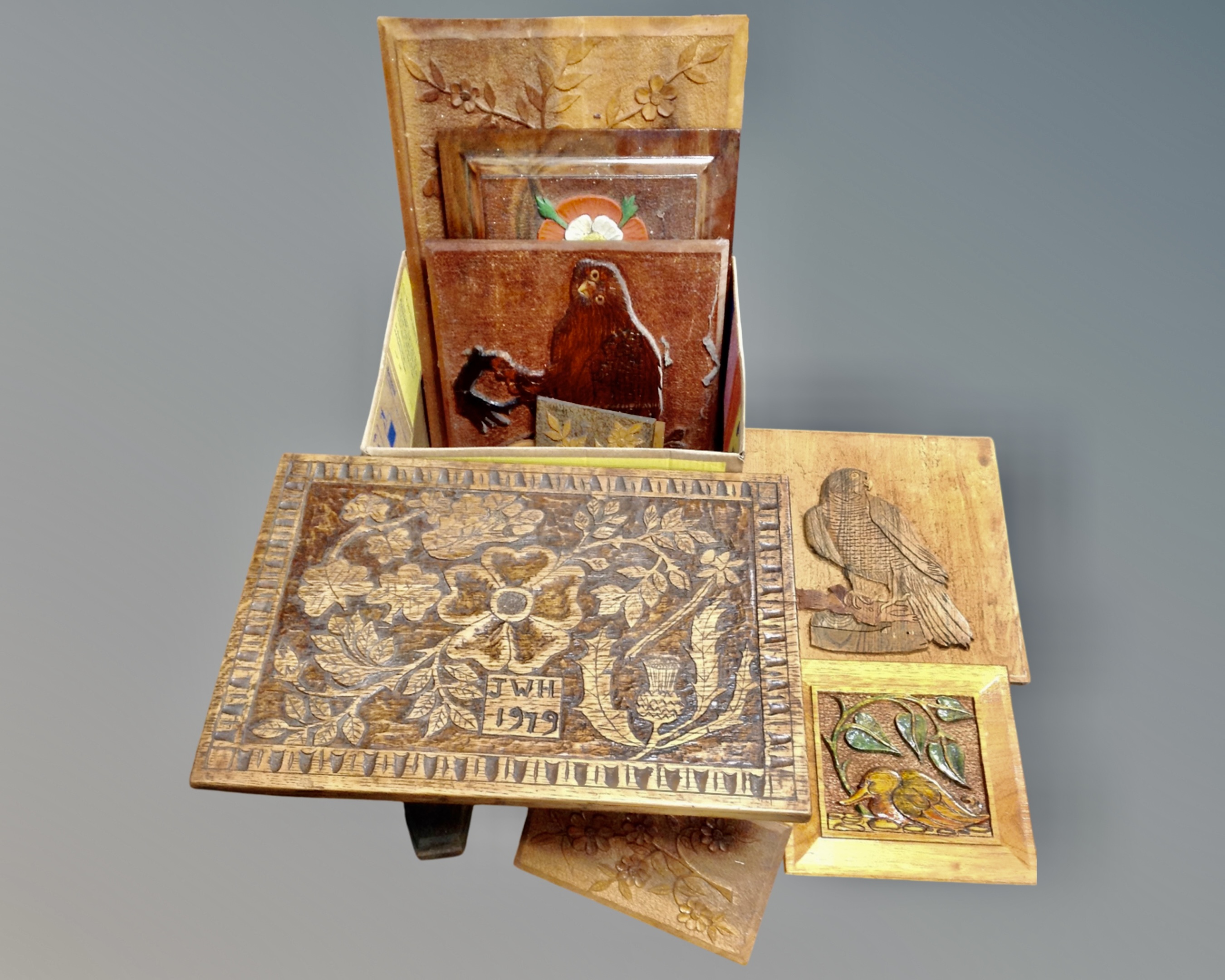 A carved oak miniature refectory coffee table together with a box containing a quantity of wooden