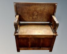 A carved oak monk's bench (width 84cm)