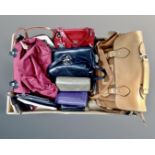 A box containing a quantity of assorted leather handbags and purses.