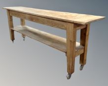 An antique pine two tier kitchen work table (length 216cm,