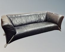 A Rolf Benz settee on raised legs upholstered in black leather.