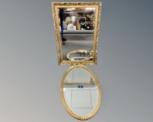 An oval gilt framed bevel edged mirror together with a further gilt framed mirror.