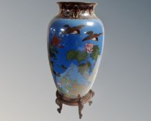 A Japanese Meiji period cloisonné vase on blue ground depicting birds and foliage, height 31cm,