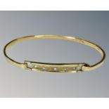 A yellow gold bangle set with diamonds, approx 6cm diameter, 9.6g.