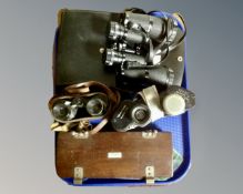 A tray containing three pairs of field glasses including Zenith 12x50, Revue 10x50, Prisma of Paris,