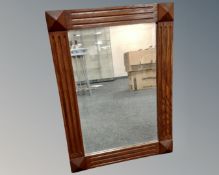 An oak framed bevel edged mirror (width 56cm)