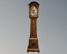 A 19th century continental oak longcase clock with brass and silvered dial,