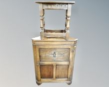 A carved oak corner cabinet together with a Jaycee oak occasional table.