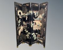 A Japanese black lacquered four fold screen.