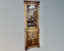 Two carved oak leaded glass door corner display cabinets fitted with cupboards beneath (2)