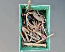 A crate containing a quantity of vintage hand tools including files, hammers, egg beater drill.