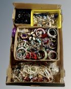 A box containing a large quantity of costume jewellery including bangles, beaded necklaces,