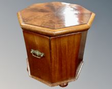 A 19th century octagonal mahogany commode with brass handles.