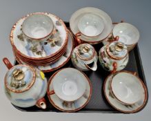 A tray containing a 20th century Japanese export eggshell tea service.