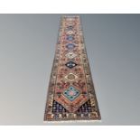 A Persian Heriz runner 85 cm x 400 cm