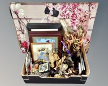 A box containing Oriental wares including figural table lamp, coasters, prints, collages in frame,