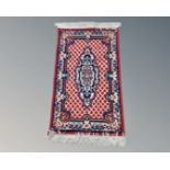 A small eastern woollen rug,
