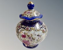 A Chinese style lidded vase decorated with flowers.