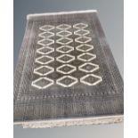 A Lahore Bokhara carpet, Pakistan, on cream ground with repeat lattice central field,