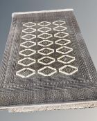 A Lahore Bokhara carpet, Pakistan, on cream ground with repeat lattice central field,