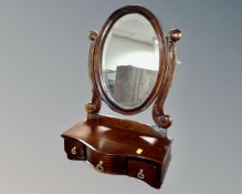 A Victorian style mahogany toilet mirror fitted with three drawers.