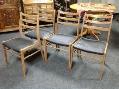 A set of four 1970s teak ladder backed dining chairs.