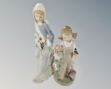 Two Lladro figures, girl with bird in hand and seated girl with lilies.