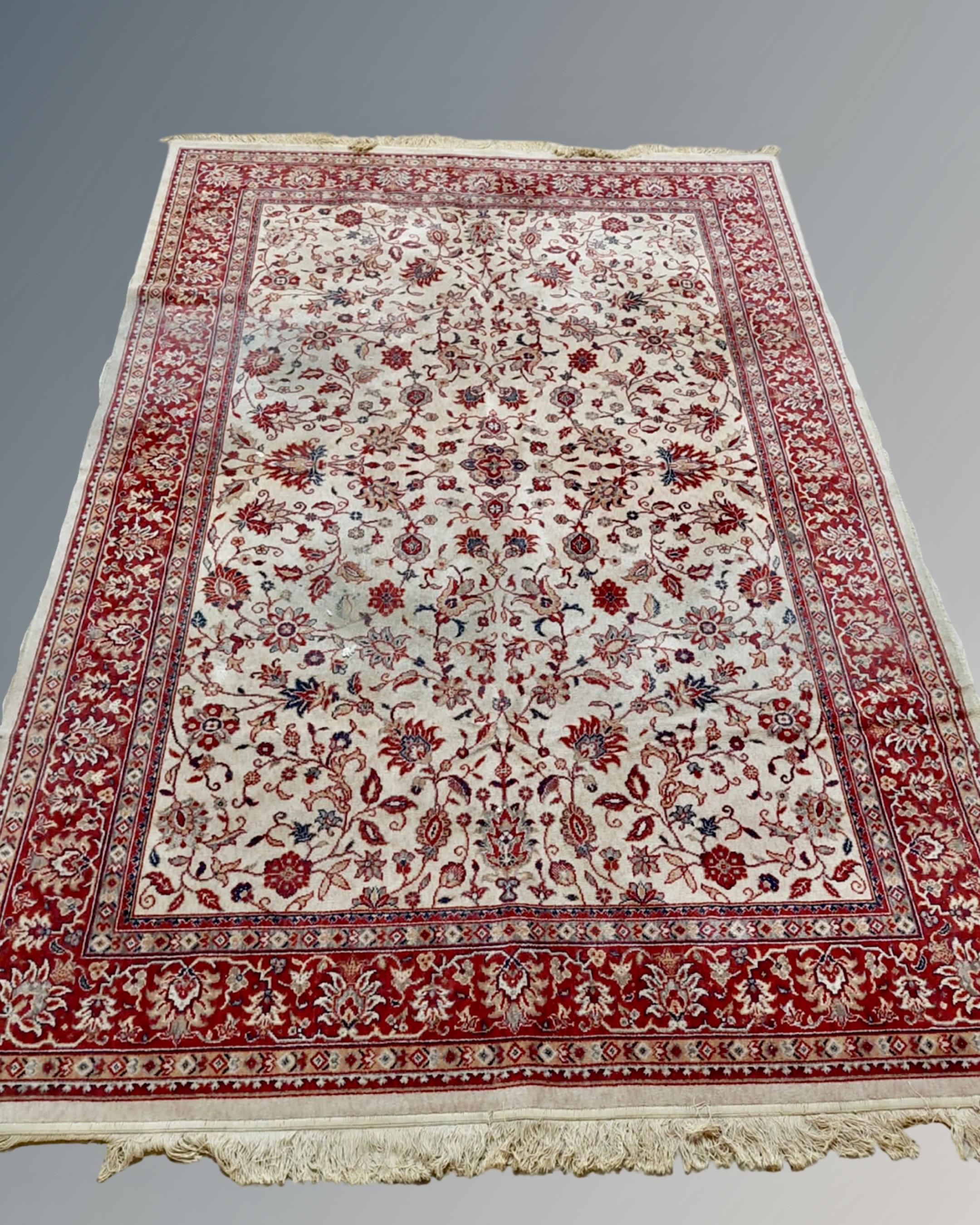 An Isfahan design carpet on red and cream ground,