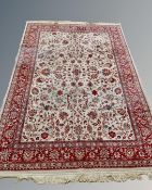 An Isfahan design carpet on red and cream ground,