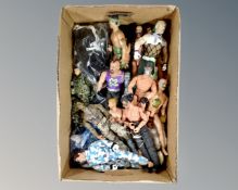 A box containing a quantity of Action Man figures and accessories.