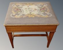 A 20th century inlaid satinwood storage piano stool with tapestry top.