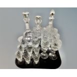 A tray containing assorted glassware including three cut glass lead crystal decanters together with