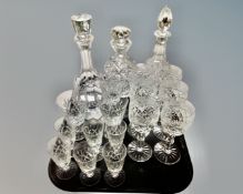 A tray containing assorted glassware including three cut glass lead crystal decanters together with